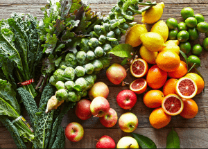 a group of fruits and vegetables on a wood surface Healthy Weight Loss Diets Bishops Stortford