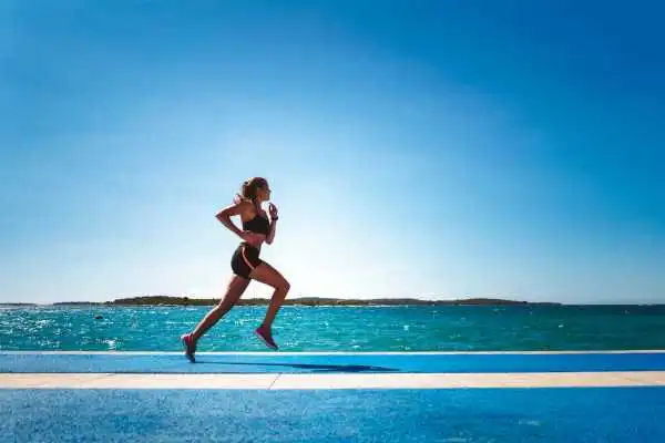 Woman running showing strong leg muscle Bishops Stortford